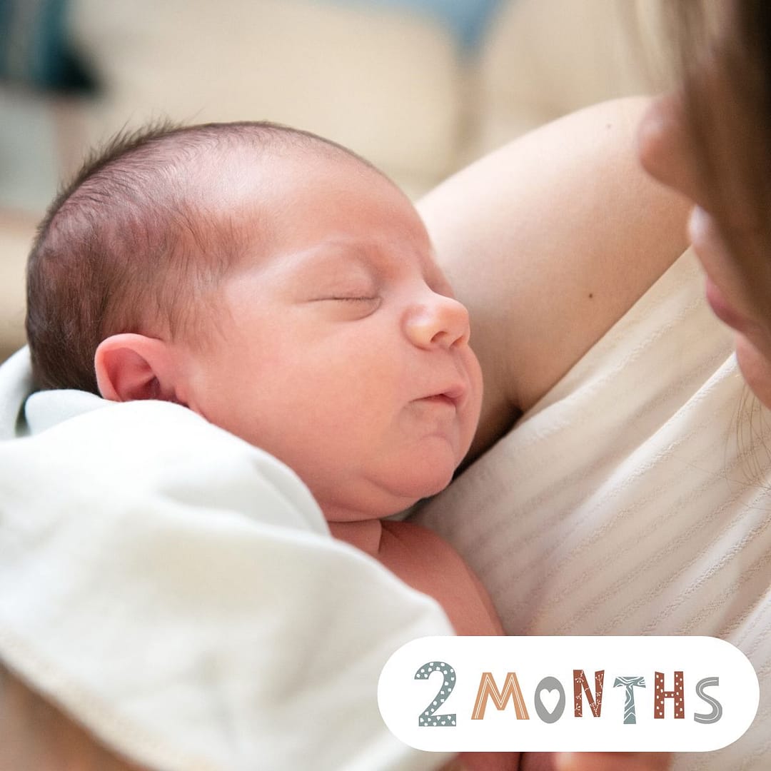 2-month-old baby smiling during tummy time – baby milestone by month, early development, and bonding