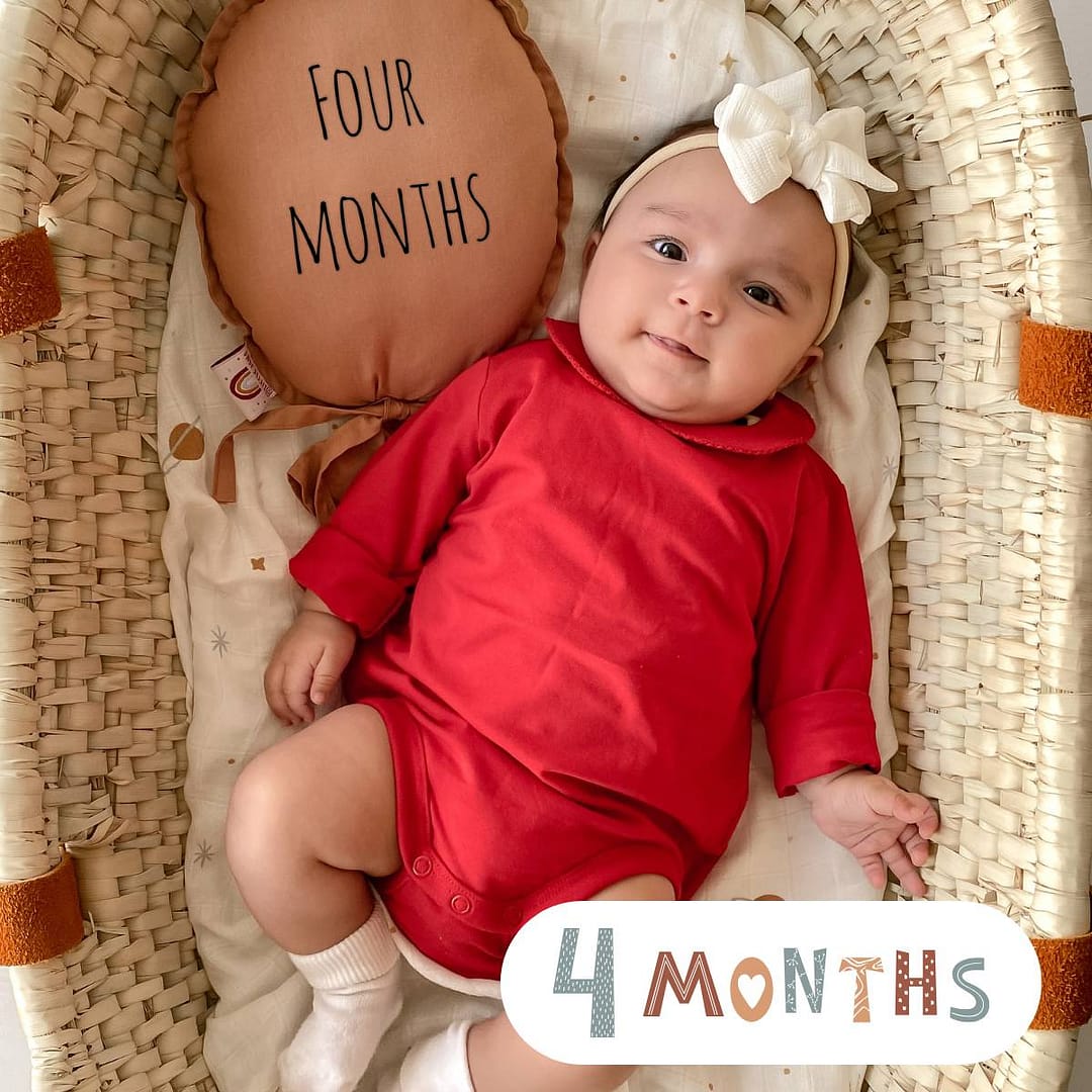 4-month-old baby exploring with toys – baby milestone by month achievements and early sensory development support
