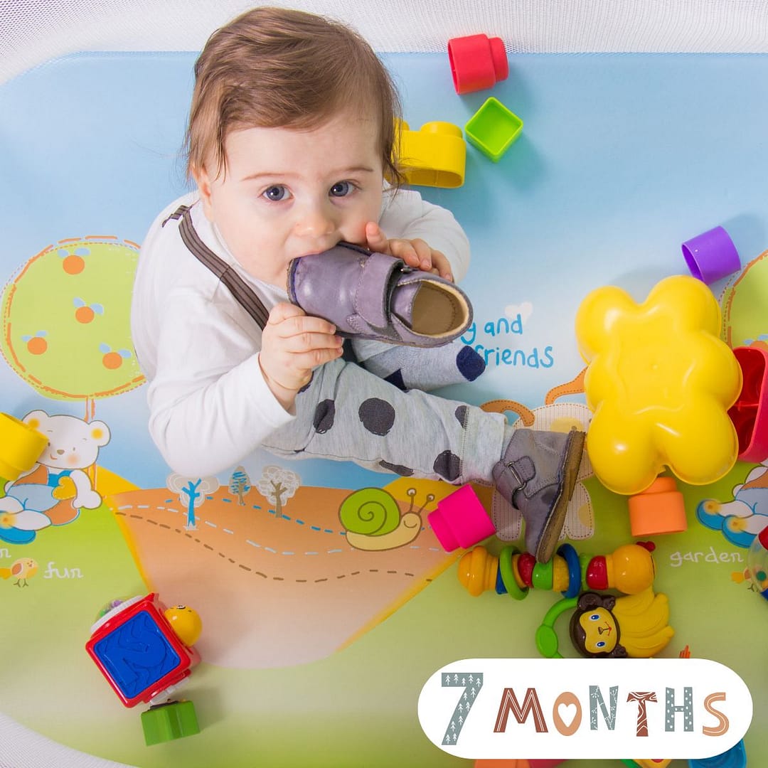 7-month-old baby crawling and reaching for toys – baby milestone by month skills, growth patterns, and early exploration