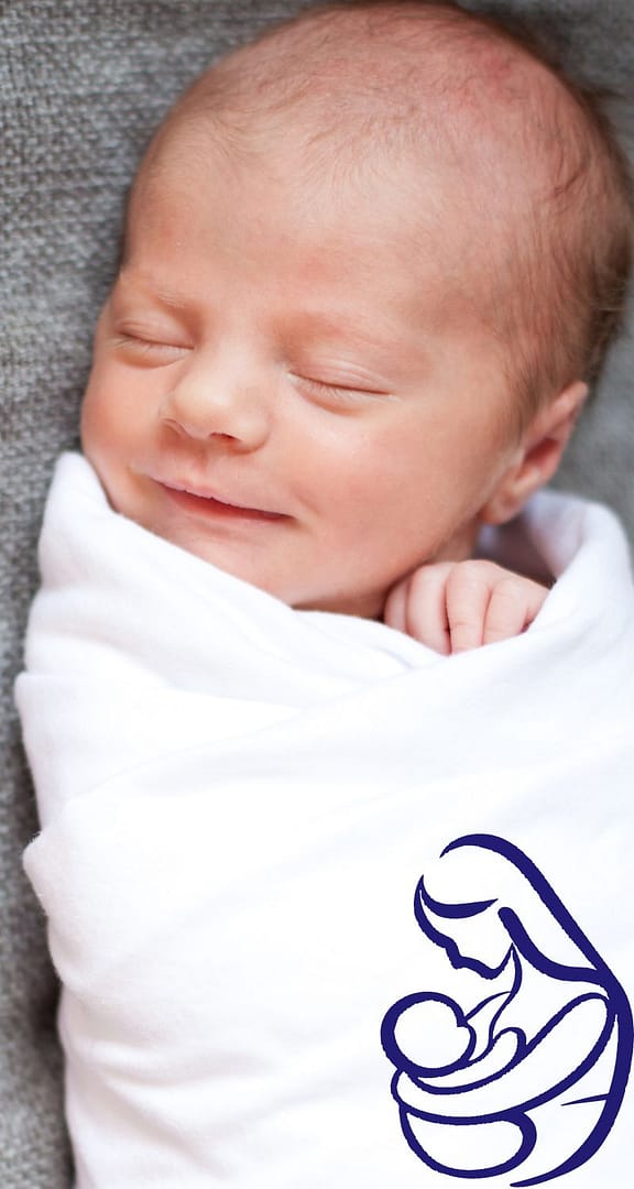 Newborn sleeping safely on a firm crib mattress with breathable bedding